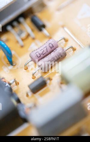 A detailed macro shot of electronic components on a circuit board, showcasing resistors and connectors Ideal for illustrating TV repair or electronic Stock Photo