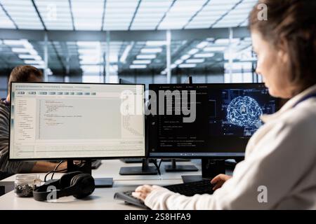 Woman using artificial intelligence technology to optimize data center performance. IT professional in server farm using AI tech to streamline operations and accurately forecast potential issues Stock Photo