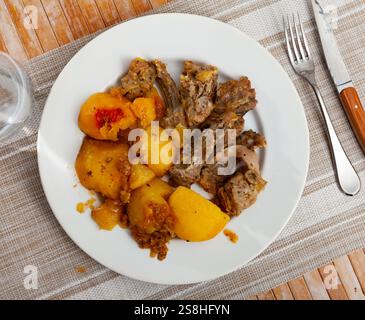 Braised rabbit served with potato garnish Stock Photo