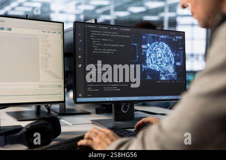 Engineer doing data center automation using AI and machine learning tools. IT professional integrating artificial intelligence driven automation in server farm operations Stock Photo