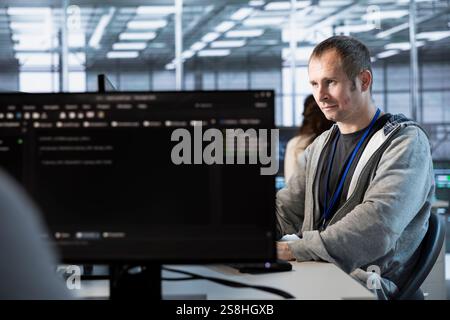 Computer scientist in data center managing and optimizing IT infrastructure using network management skills. Server room employee upgrading gear, reducing operational costs Stock Photo