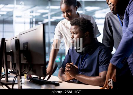 Team of data center employees working together to create technical documentation for software applications. Server room colleagues doing brainstorming, maintaining databases Stock Photo