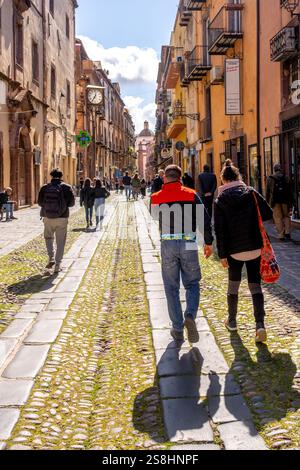 Tourists in a pedestrian zone, artistic balcony and flower arrangements, Bosa, Europe, Province of Oristano, Italy Stock Photo