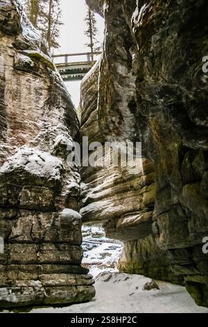 A narrow passage between two large rocks on a beach, showcasing ...