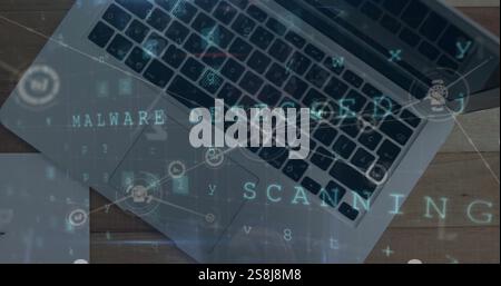Image of malware detected text with network and data processing over laptop on desk Stock Photo