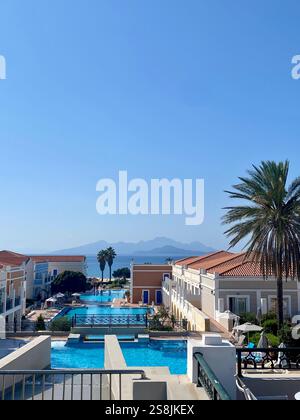 High angle view of buildings against clear blue sky with an island view in the background Stock Photo