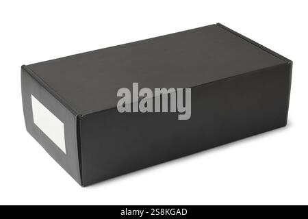 close-up of black rectangular cardboard box isolated white background, small white blank label on the side, mock-up template Stock Photo