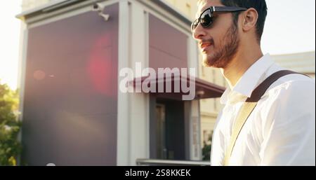 Business, man and walking with sunglasses in city for real estate, showcase viewing or morning commute. Professional, male consultant and explore with Stock Photo