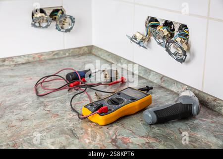 Fixing and repairing broken outlets and socket with tools and ammeter Stock Photo
