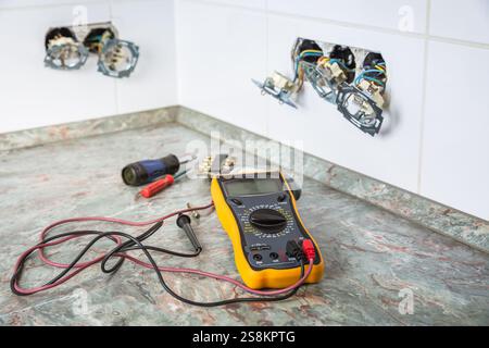 Fixing and repairing broken outlets and socket with tools and ammeter Stock Photo
