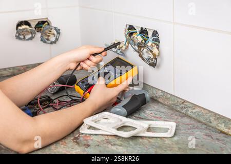 Fixing and repairing broken outlets and socket with tools and ammeter Stock Photo