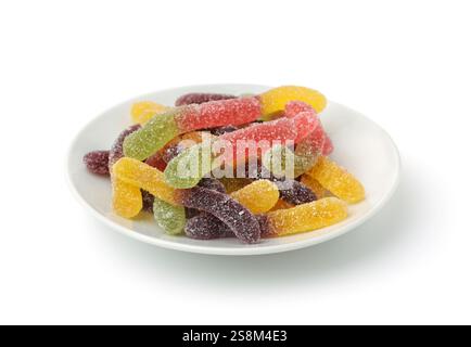 Colorful chewy jelly worms in white ceramic plate isolated on white Stock Photo