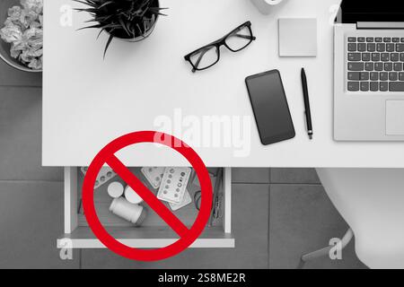 Many medicines hidden in the work desk drawer and prohibition sign, substance abuse and drugs addiction concept Stock Photo