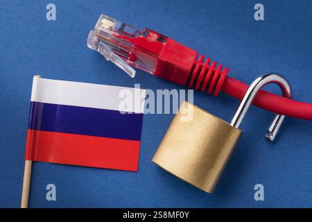 Open lock on network computer cable and Russian flag on blue background, concept on the topic of open internet in the country Stock Photo