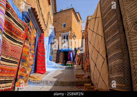 Chefchaouen, Morocco. Carpet shop and colorful carpets inside the blue city Medina. Beautiful Moroccan cityscape and traditional business. Stock Photo