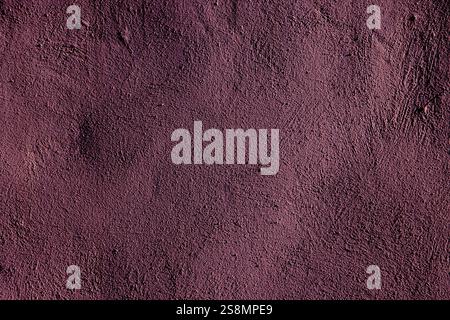A richly detailed textured purple wall with rugged marks, suitable for backgrounds or design use. Stock Photo