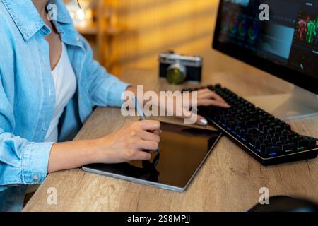 A freelance graphic designer working on video editing at home Stock Photo