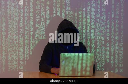 Hacking and malware concept. Hacker using abstract laptop  with binary code digital on background. Stock Photo