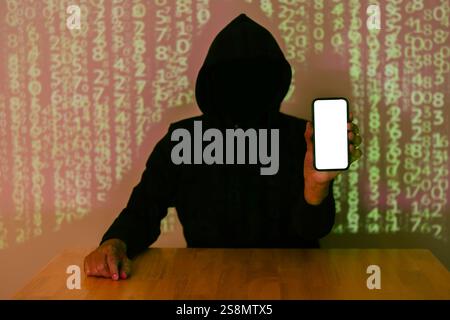 Dark face hacker holding smartphone with isolate screen over binary code digital background. Copy space. Stock Photo