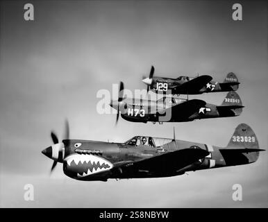 The Curtiss P-40 Warhawks flying in formation; the American single-engined, single-seat, all-metal fighter-bomber first flew in 1938. The aircraft was used by most Allied powers during World War II, and remained in frontline service until the end of the war.  P-40s first saw combat with the British Commonwealth squadrons of the Desert Air Force in the Middle East and North African campaigns, during June 1941. The RAF Squadron No. 112 was the first Allied military aviation unit to feature the 'shark mouth' logo, copying markings on Luftwaffe Messerschmitt Bf 110 fighters. Stock Photo