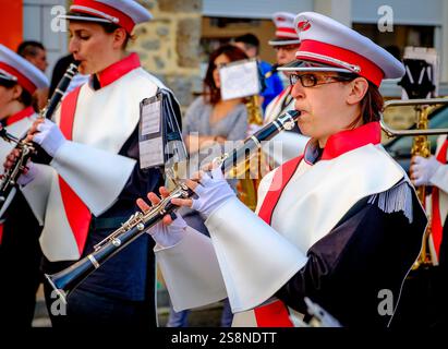 A marching band lead a parade in the town of Villaines-la-Juhel, Pays de la Loire, France during Bastille Day celebrations in the town (La fête nation Stock Photo
