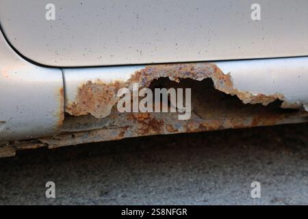 Rusting door sill in an old car. Weather damage in vehicle. Stock Photo