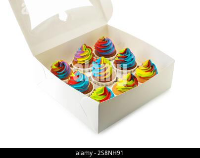 Tasty cupcakes with colorful cream in box isolated on white Stock Photo