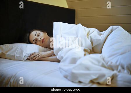 Young woman sleeping peacefully in her bedroom Stock Photo