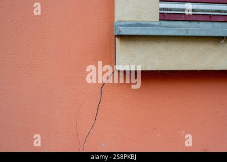 Crack in a wall construction defects symbol Stock Photo