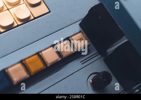 A closeup view of a vintage control panel featuring a test button and multiple switches for industrial or technological settings Stock Photo