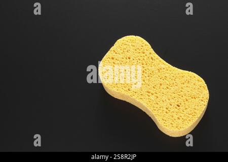 An image of a yellow sponge isolated on black background Stock Photo