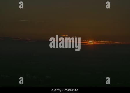 Faint sunset behind dark clouds in the evening sky, Straubing, Lower Bavaria Stock Photo