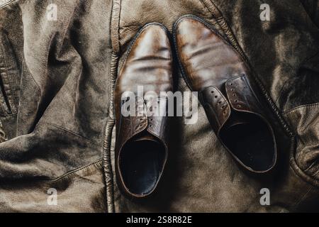 Brown leather shoes paired with a leather jacket, enhancing a vintage and rustic feel Stock Photo
