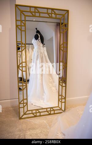 Wedding dress in a hotel room reflected in a mirror. Stock Photo