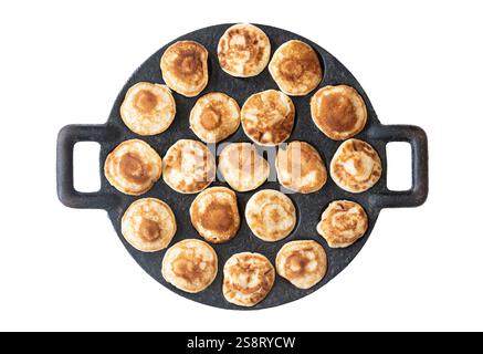 Dutch poffertjes on cast iron poffertjes pan isolated on white Stock Photo