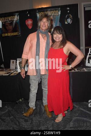 Actor Ronn Moss and model Devin Devasquez pose for photos at the
