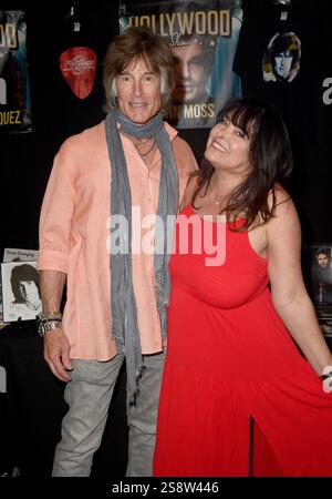 Actor Ronn Moss and model Devin Devasquez pose for photos at the