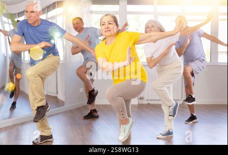 Group of aged people rehearsing sports dance in dance class Stock Photo