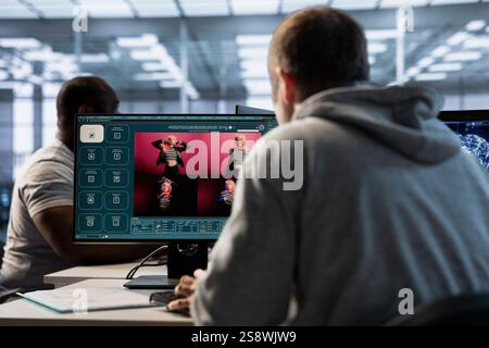 Technician in server hub making generative artificial intelligence website generating videos using diffusion model algorithms. Employee coding AI virtual assistant producing clips Stock Photo