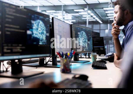Computer scientists in data center using artificial intelligence system monitoring software to identify errors. Machine learning specialist in AI server farm establishment repairing equipment Stock Photo