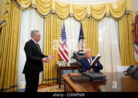 President Donald Trump signs an executive order in the Oval Office of