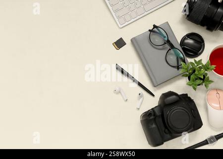 Composition with professional photographer's equipment, modern gadgets and stationery on light background Stock Photo