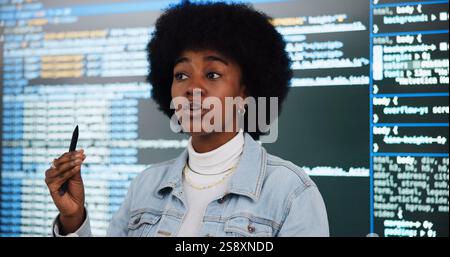 Programming lecture, student and woman in college for learning, education and teaching ai course. African person, class and study coding with data for Stock Photo