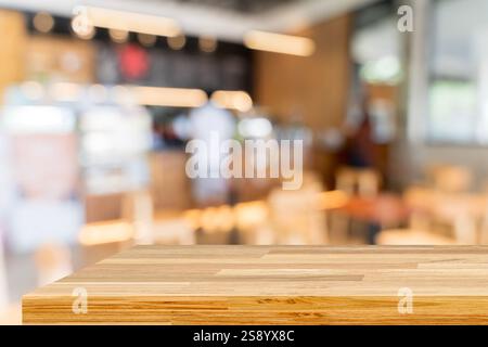 Wooden board empty table in front of blurred background.  Brown wood over blur in coffee shop. Can be used for display or montage your products. Mock Stock Photo