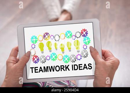 Teamwork idea concept shown on a tablet held by a woman Stock Photo
