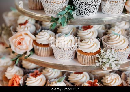 Elegant cupcake display with floral accents and intricate designs Stock Photo