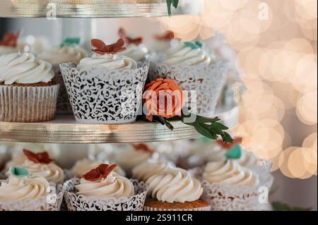 Elegant cupcake display with floral accents and intricate designs Stock Photo