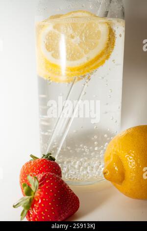 Close-up of a sparkling lemon water with strawberries and eco-fr Stock Photo