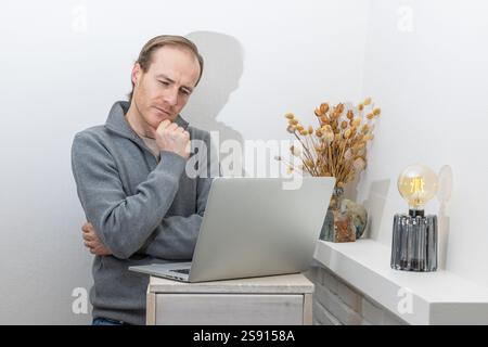 Thoughtful Professional Analyzing Data on a Laptop Stock Photo