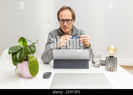 Focused Entrepreneur Listening and Thinking While holding a pen Stock Photo
